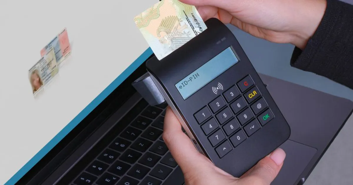 Person using contactless device for ID payment verification on a laptop.