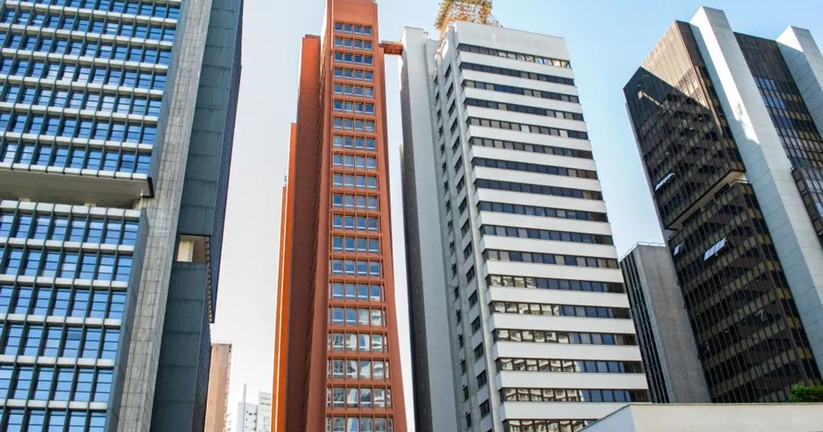 View of modern skyscrapers under a clear blue sky in an urban cityscape.