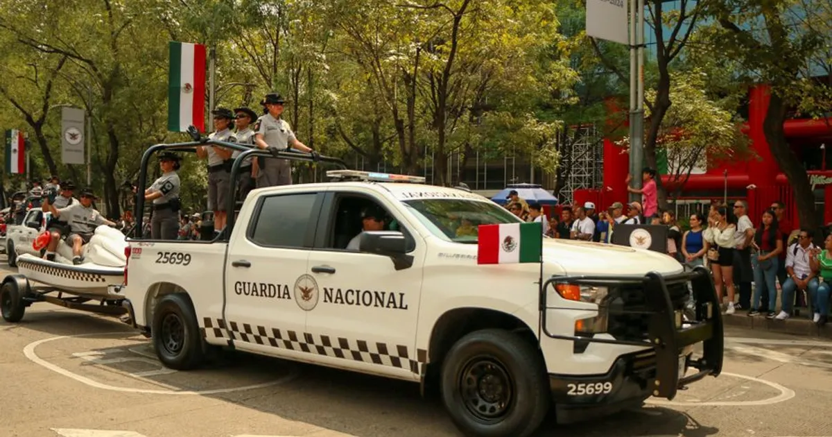 Mexican National Guard vehicle participating in an outdoor military parade, showcasing security forces.